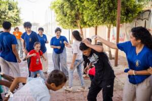 Volunteers and children playing water balloon games in Egypt
