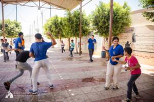 Volunteers and children playing water balloon games in Egypt