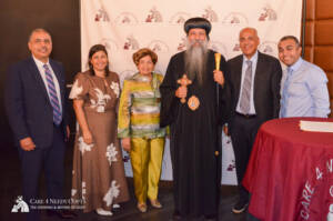 His Grace Bishop David, Bishop of the Coptic Orthodox Diocese of New York and New England with Laila Sidhom the founder and President of the Board of Directors for Care 4 Needy Copts and Youssef Hanna a Digital Marketing and Graphic Design Director at care 4 needy copts with Ehab Faltaous President and Chairman of the Board of The Shepherd and Mother of Light (SML), and Founder and CEO of Felopateer Palace